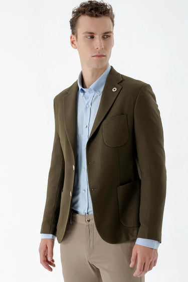 Man wearing khaki woven slim fit blazer with light blue shirt and beige trousers