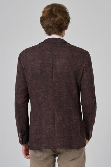 Back view of man wearing brown check patterned knit blazer