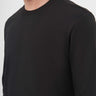 Close-up of man wearing a black crew neck long sleeve t-shirt, minimalist style