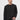 Man wearing black crew neck sweatshirt and light grey pants on white background