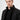 Man wearing a black snap-button jacket with high collar, stylish modern outerwear