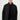 Man wearing a black snap-button jacket with high collar and front pockets, fashion photo