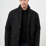 Man wearing a black snap-button jacket with high collar and front pockets, fashion photo